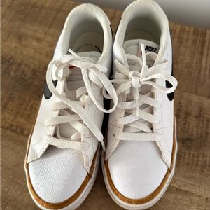 Nike White Sneakers with Black and Gold Accents